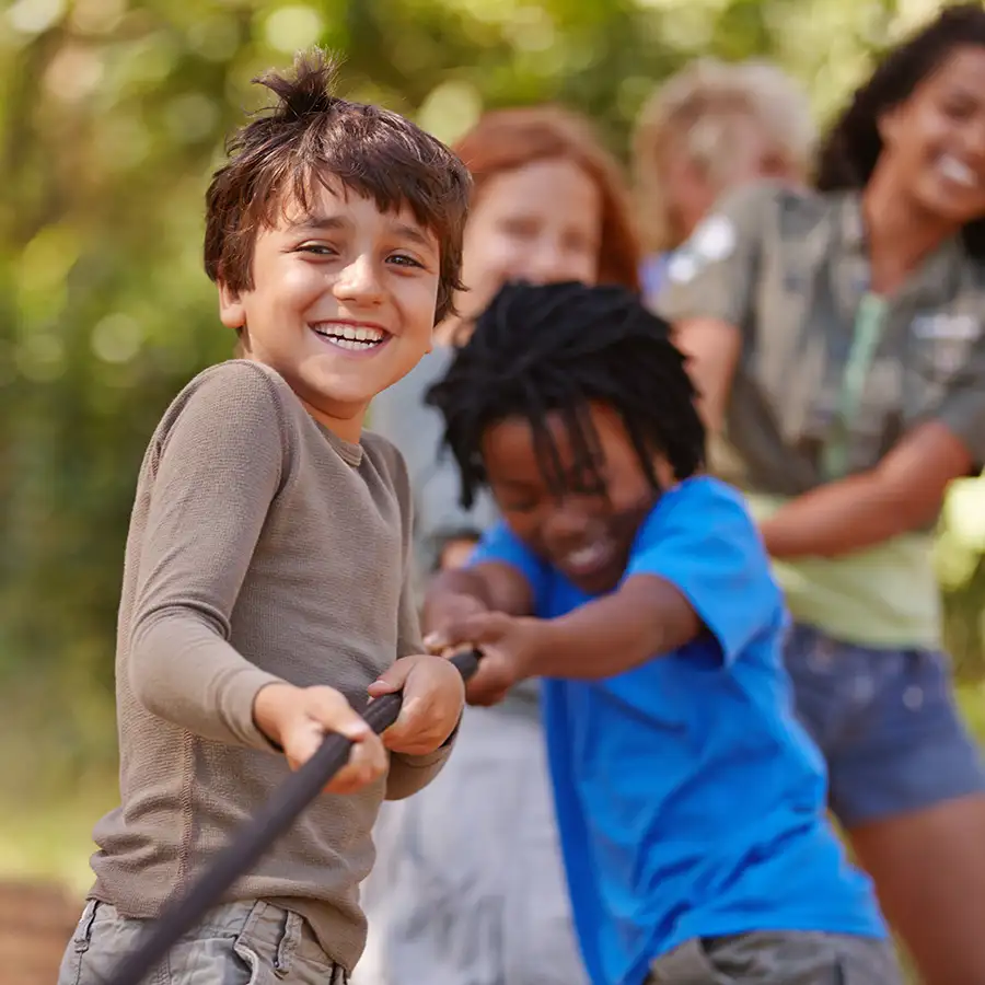 children at summer camp playing tug of war, getting back to having fun because of super effective head lice treatment - St. Charles, MO