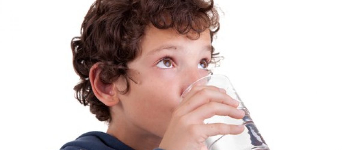 Cute boy drinking water